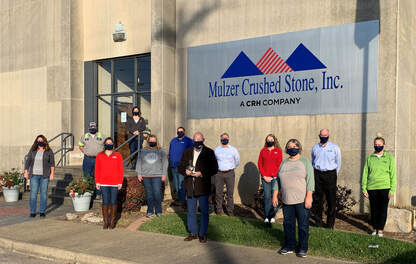 LHDC and Mulzer employees posing in front of Mulzer building